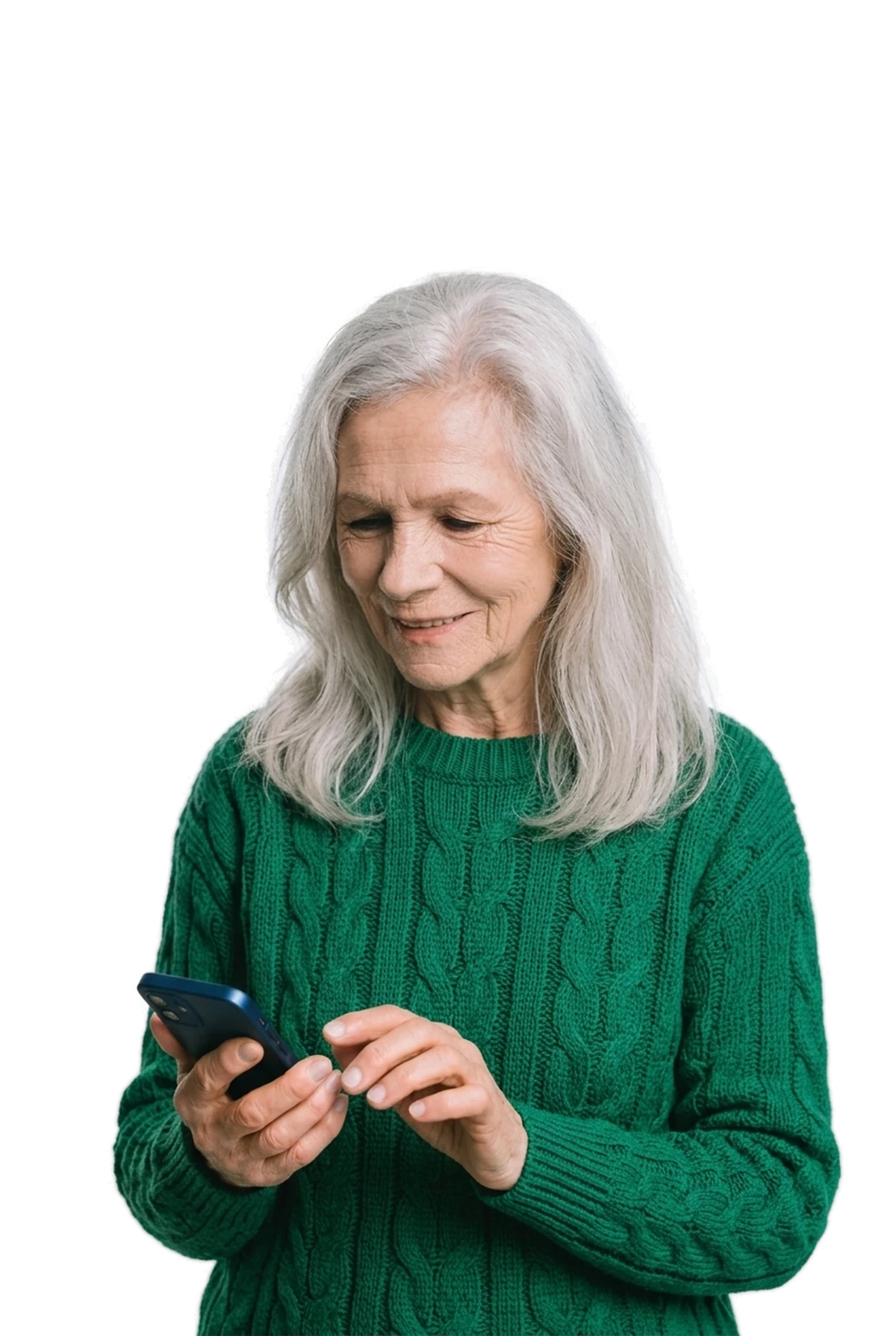 An older woman in a green sweater smiling at her smartphone